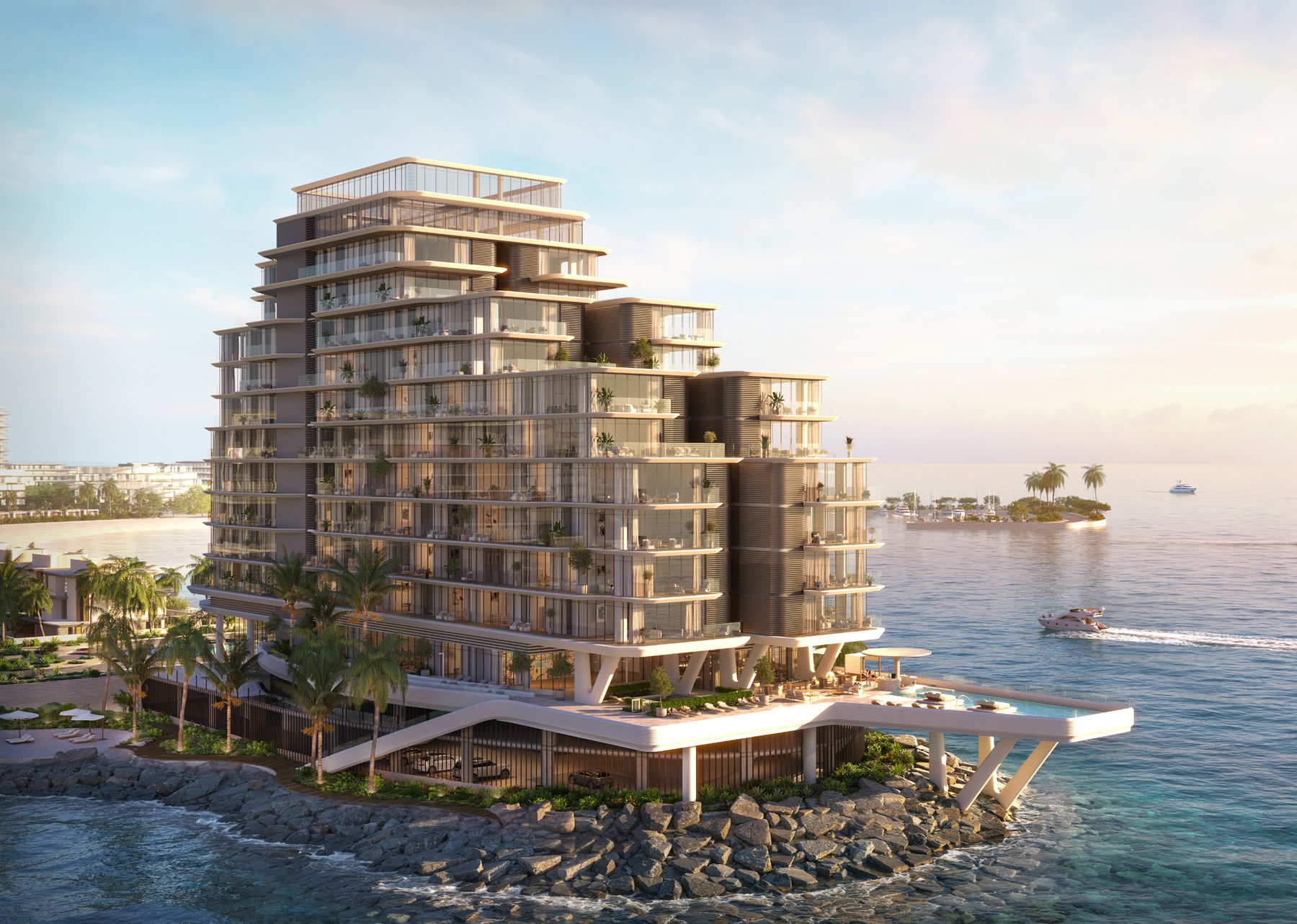 Anantara Residences Mina Ras Al Khaimah seen from the water at sunset, with the marina beyond