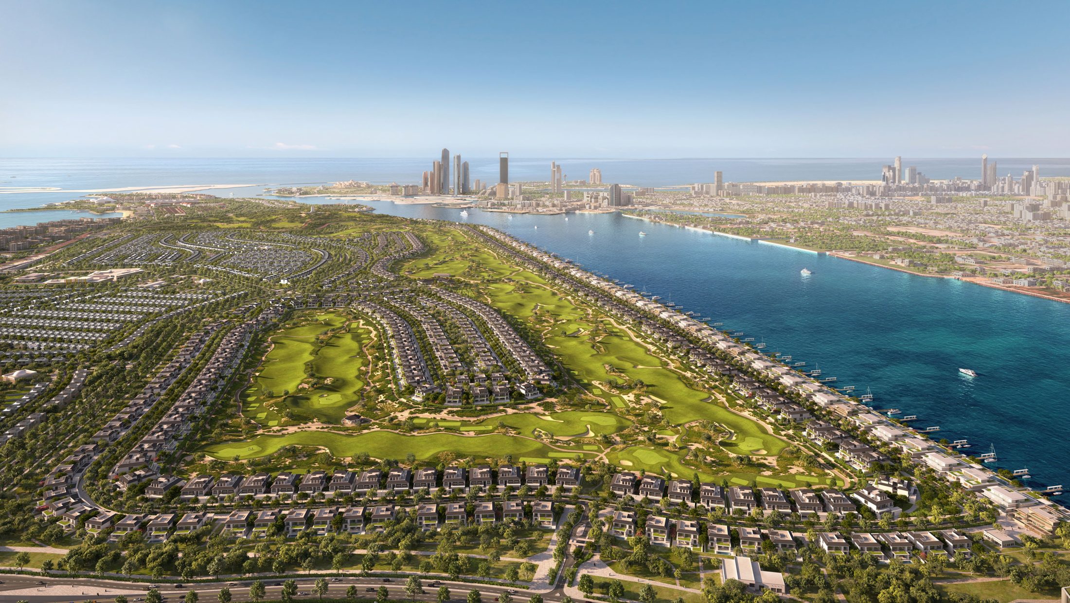 Aerial view of the Hudayriyat Golf Estates master community with the Abu Dhabi skyline across the water