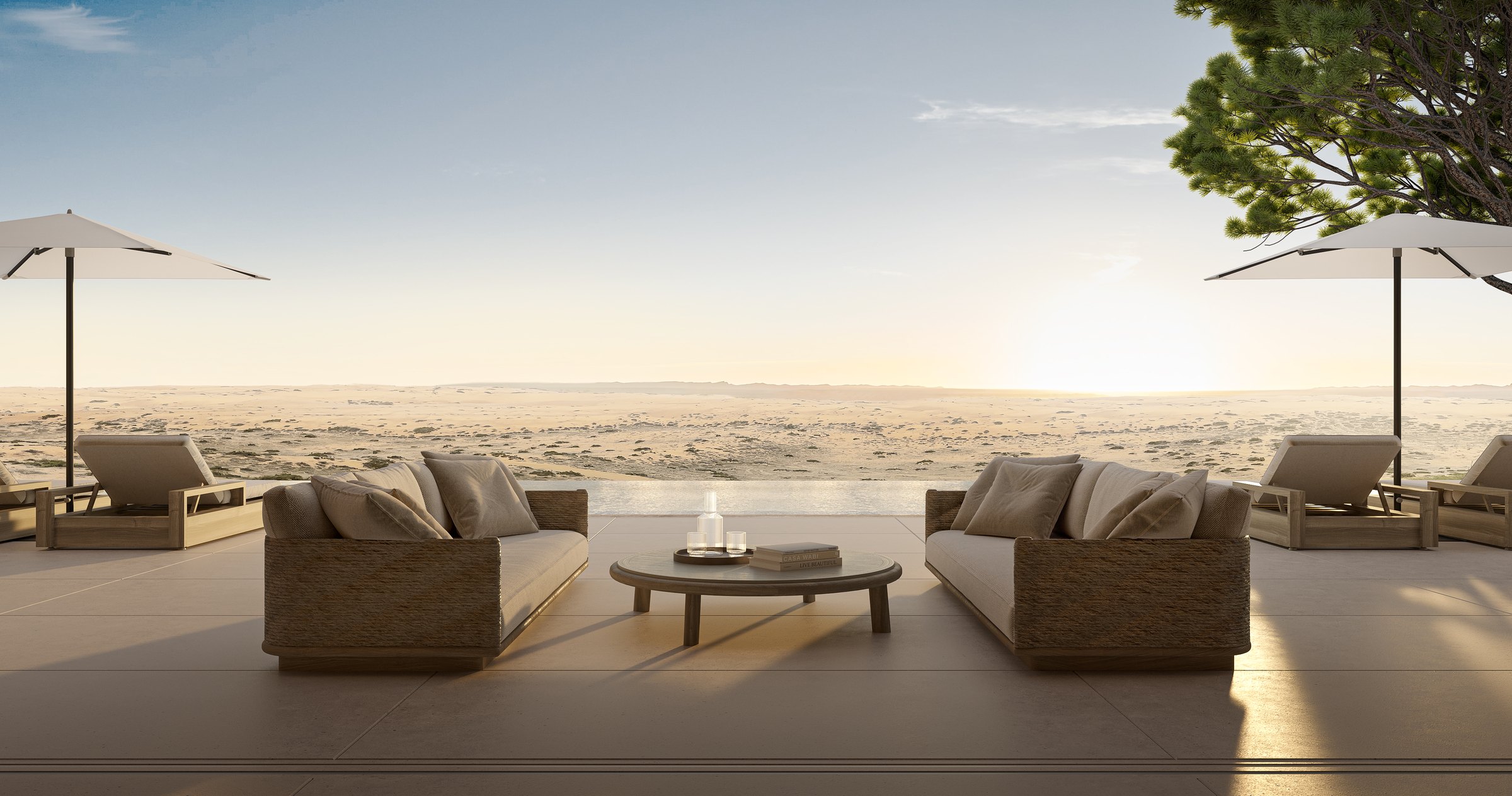 Villa pool terrace at sunset, looking out over the Al Wadi desert reserve